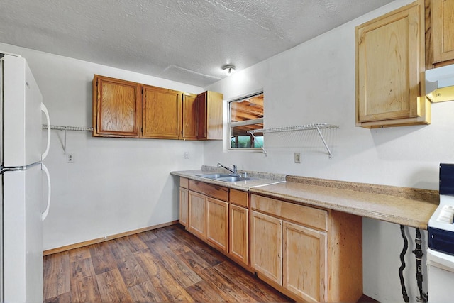 1237 Gabaldon Rd, Belen, NM 87002 - kitchen with freestanding refrigerator, a sink, dark wood finished floors, light countertops, and a textured ceiling