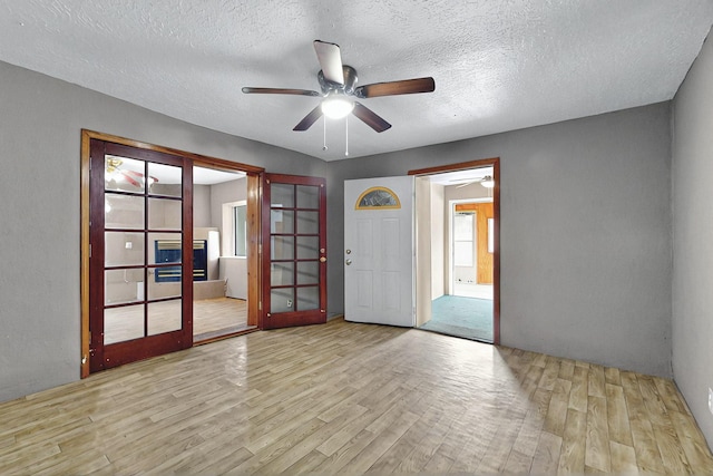 1237 Gabaldon Rd, Belen, NM 87002 - spare room featuring a ceiling fan, wood finished floors, a textured ceiling, and french doors