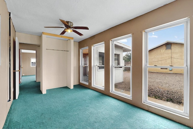 1237 Gabaldon Rd, Belen, NM 87002 - unfurnished bedroom featuring carpet flooring, a closet, a textured ceiling, and a ceiling fan