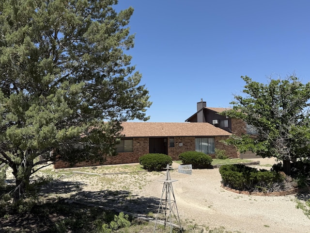 2833 Tiffany Rd, Tucumcari, NM 88401 - view of front facade featuring brick siding and a chimney