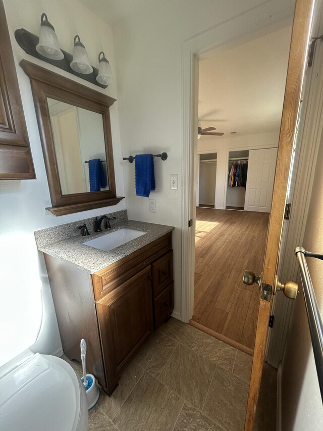 2833 Tiffany Rd, Tucumcari, NM 88401 - half bath featuring vanity, toilet, and a ceiling fan