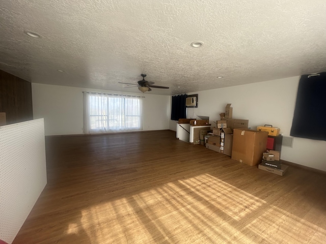 2833 Tiffany Rd, Tucumcari, NM 88401 - unfurnished living room featuring wood finished floors, a textured ceiling, and ceiling fan