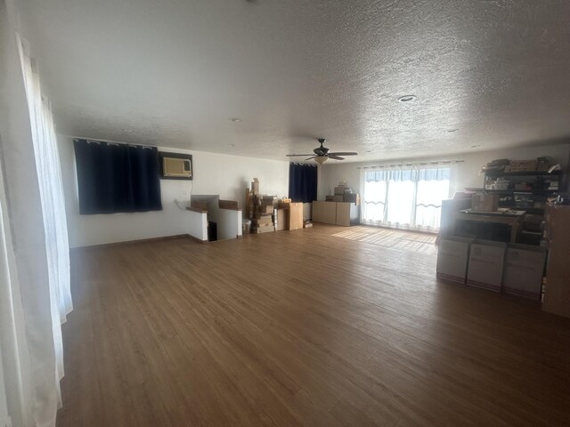 2833 Tiffany Rd, Tucumcari, NM 88401 - living area with wood finished floors, a textured ceiling, ceiling fan, and a wall unit AC