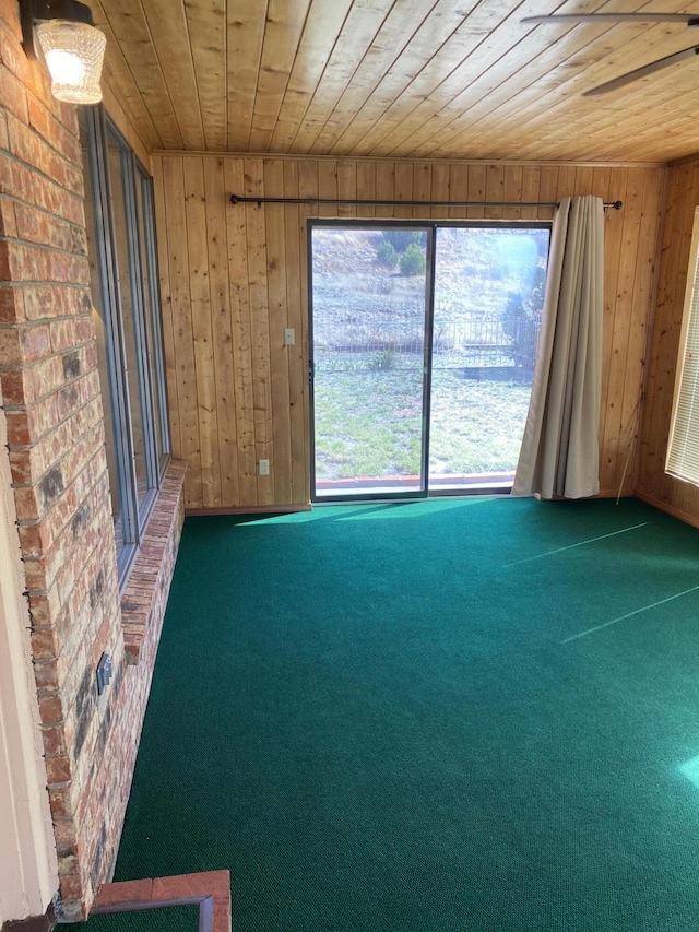 2833 Tiffany Rd, Tucumcari, NM 88401 - carpeted empty room featuring wooden ceiling and wooden walls