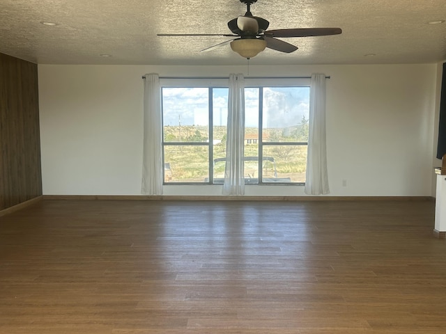 2833 Tiffany Rd, Tucumcari, NM 88401 - empty room with wood finished floors, ceiling fan, a textured ceiling, and baseboards