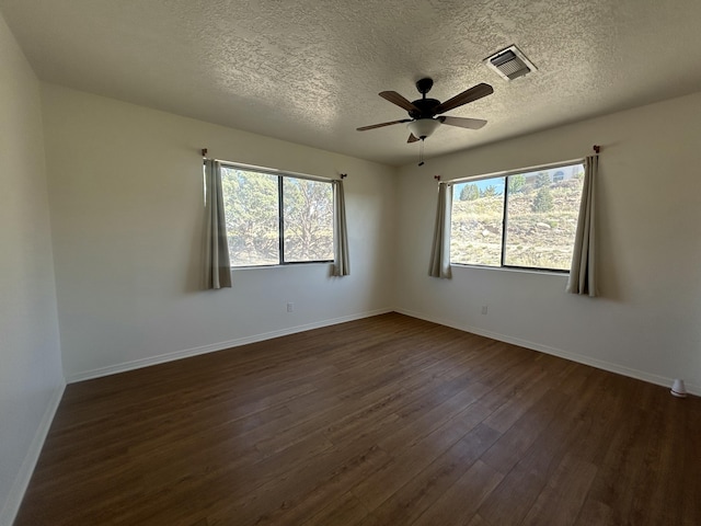 2833 Tiffany Rd, Tucumcari, NM 88401 - unfurnished room with dark wood finished floors, a ceiling fan, baseboards, and a textured ceiling