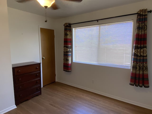 2833 Tiffany Rd, Tucumcari, NM 88401 - spare room featuring wood finished floors, ceiling fan, and baseboards