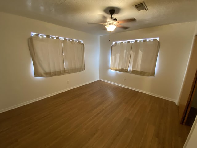 2833 Tiffany Rd, Tucumcari, NM 88401 - unfurnished room with wood finished floors, baseboards, ceiling fan, and a textured ceiling