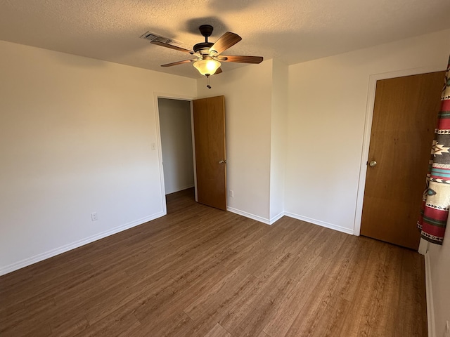 2833 Tiffany Rd, Tucumcari, NM 88401 - unfurnished room with wood finished floors, ceiling fan, a textured ceiling, and baseboards