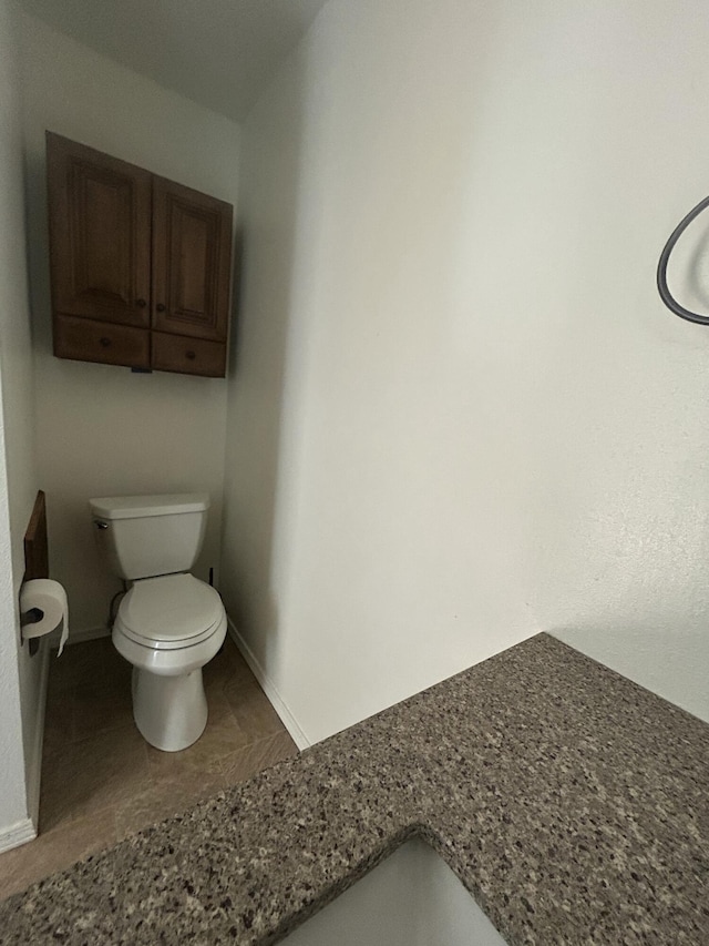2833 Tiffany Rd, Tucumcari, NM 88401 - bathroom with toilet and baseboards