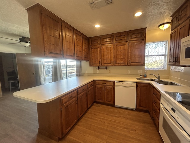 2833 Tiffany Rd, Tucumcari, NM 88401 - kitchen featuring white appliances, a peninsula, a textured ceiling, a ceiling fan, and recessed lighting