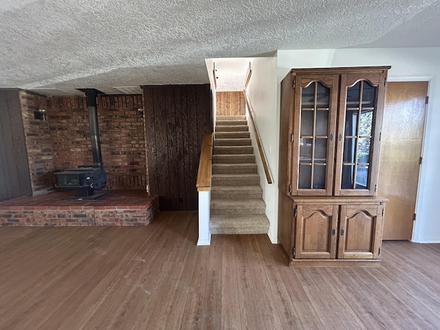 2833 Tiffany Rd, Tucumcari, NM 88401 - staircase with a textured ceiling, wood finished floors, and a wood stove