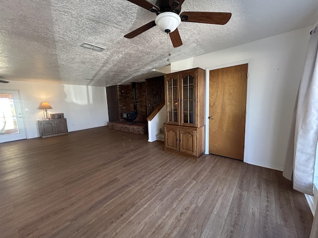 2833 Tiffany Rd, Tucumcari, NM 88401 - unfurnished living room with a textured ceiling, a ceiling fan, wood finished floors, and baseboards