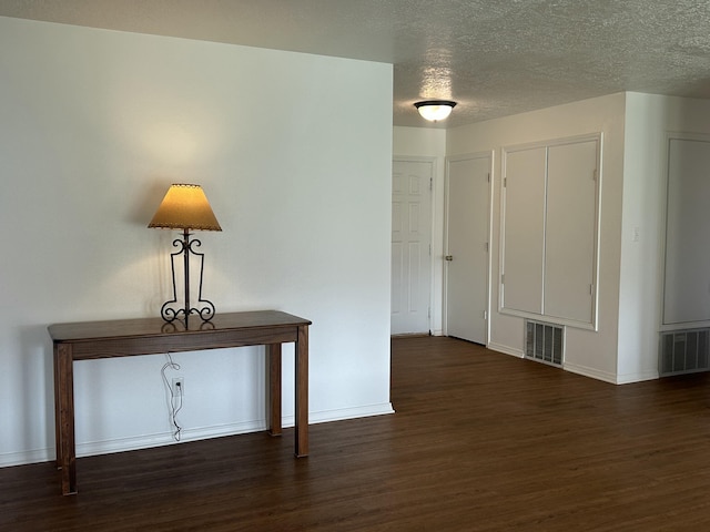 2833 Tiffany Rd, Tucumcari, NM 88401 - spare room featuring wood finished floors, baseboards, and a textured ceiling