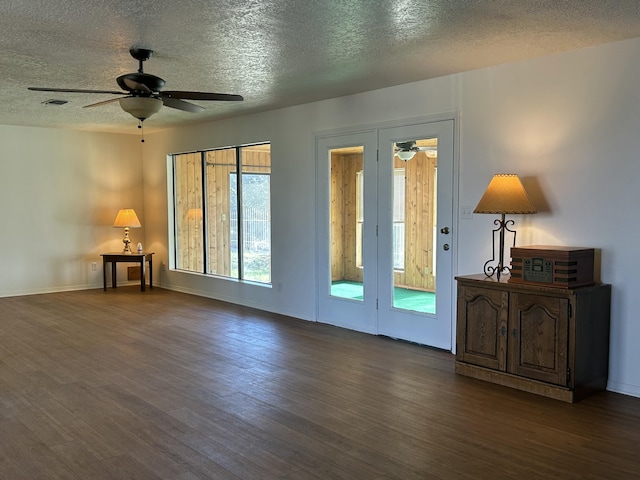 2833 Tiffany Rd, Tucumcari, NM 88401 - unfurnished room with a textured ceiling, dark wood-style flooring, ceiling fan, and baseboards