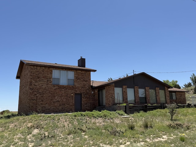 2833 Tiffany Rd, Tucumcari, NM 88401 - view of front of property with a chimney and brick siding