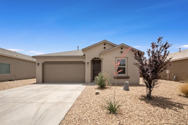 6 Margarita Cir, Los Lunas, NM 87031 - view of front facade with stucco siding, a garage, and concrete driveway