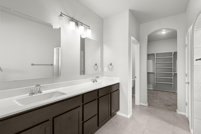 6 Margarita Cir, Los Lunas, NM 87031 - full bathroom with double vanity, a spacious closet, and tile patterned flooring