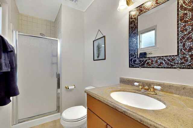 8224 Bret Pl NE, Albuquerque, NM 87109 - bathroom featuring vanity, a shower stall, and toilet