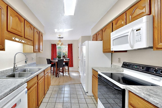 8224 Bret Pl NE, Albuquerque, NM 87109 - kitchen with white appliances, a sink, light countertops, and light tile patterned floors