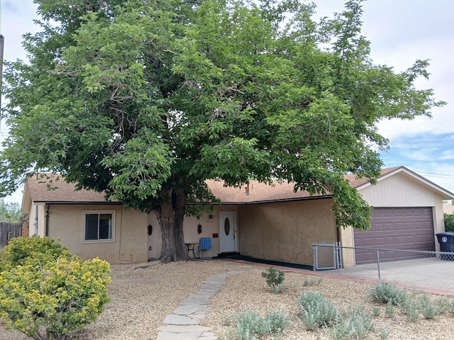 8224 Bret Pl NE, Albuquerque, NM 87109 - view of front of home with a garage, stucco siding, and concrete driveway