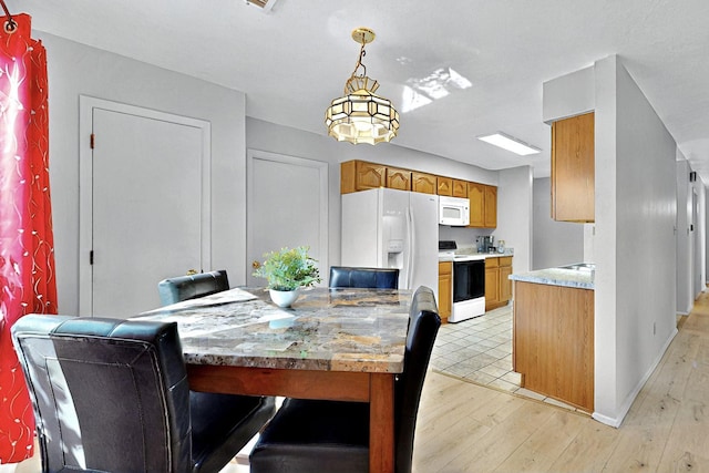 8224 Bret Pl NE, Albuquerque, NM 87109 - dining room featuring light wood-type flooring and baseboards