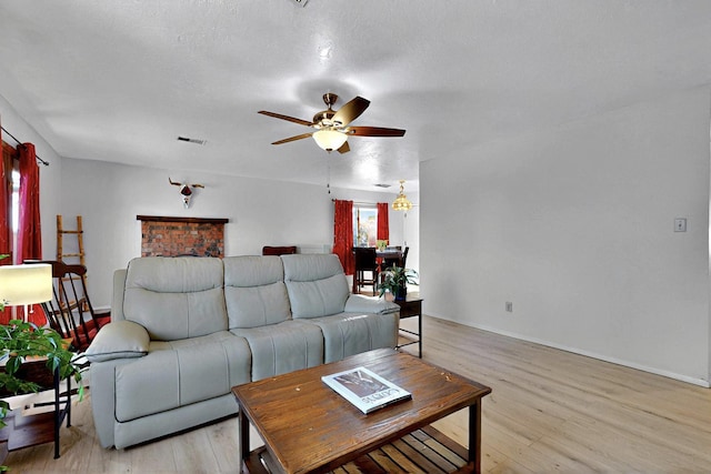 8224 Bret Pl NE, Albuquerque, NM 87109 - living area featuring a ceiling fan, light wood finished floors, and baseboards