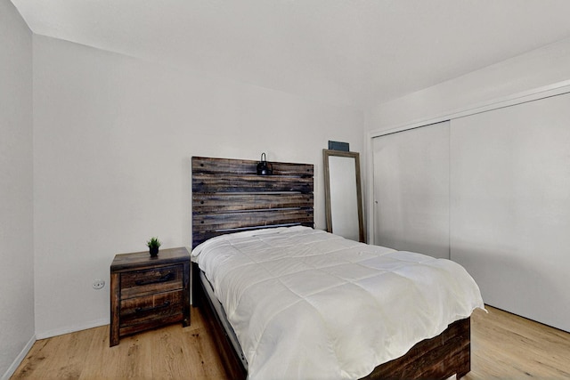 8224 Bret Pl NE, Albuquerque, NM 87109 - bedroom with wood finished floors, a closet, and baseboards