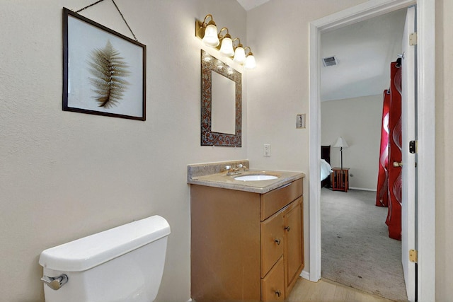 8224 Bret Pl NE, Albuquerque, NM 87109 - half bath featuring vanity, toilet, and baseboards