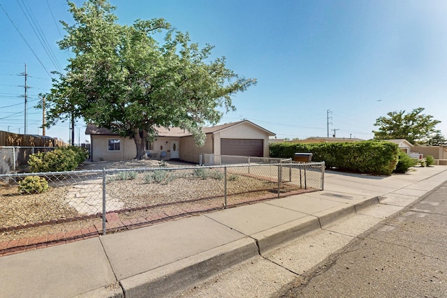 8224 Bret Pl NE, Albuquerque, NM 87109 - ranch-style house with concrete driveway, a fenced front yard, stucco siding, and an attached garage