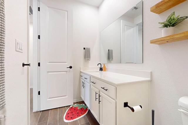 1605 Copper Mountain Trl NW, Albuquerque, NM 87120 - bathroom with vanity, toilet, and wood finished floors