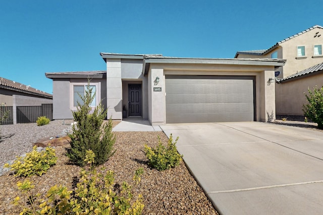 1605 Copper Mountain Trl NW, Albuquerque, NM 87120 - view of front of house with concrete driveway, a garage, and stucco siding