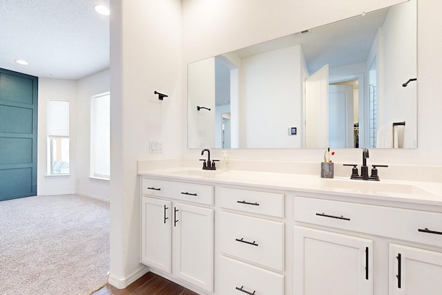 1605 Copper Mountain Trl NW, Albuquerque, NM 87120 - bathroom with baseboards, double vanity, and recessed lighting