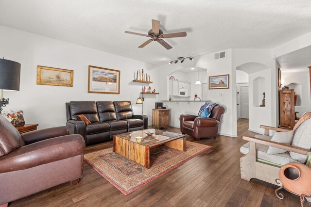3827 Fox Sparrow Trl NW, Albuquerque, NM 87120 - living area featuring ceiling fan, arched walkways, dark wood finished floors, and rail lighting