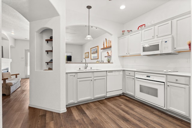 3827 Fox Sparrow Trl NW, Albuquerque, NM 87120 - kitchen featuring white appliances, a sink, light countertops, dark wood finished floors, and recessed lighting