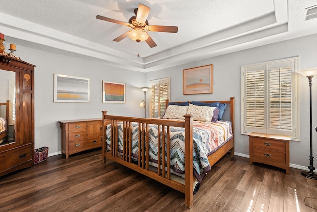 3827 Fox Sparrow Trl NW, Albuquerque, NM 87120 - bedroom featuring a raised ceiling, dark wood-style floors, baseboards, and a ceiling fan