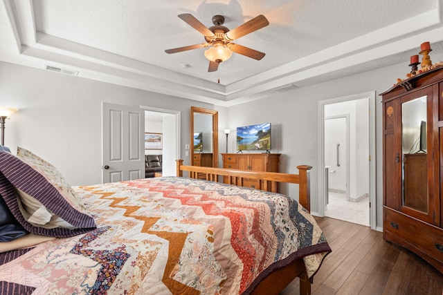 3827 Fox Sparrow Trl NW, Albuquerque, NM 87120 - bedroom with a tray ceiling, a textured ceiling, hardwood / wood-style floors, and ceiling fan