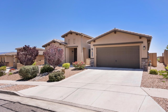 2659 Vista Manzano Loop NE, Rio Rancho, NM 87144 - mediterranean / spanish house with a garage, stucco siding, driveway, a tiled roof, and stone siding