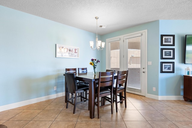 2659 Vista Manzano Loop NE, Rio Rancho, NM 87144 - dining area with a chandelier, a textured ceiling, baseboards, and light tile patterned flooring