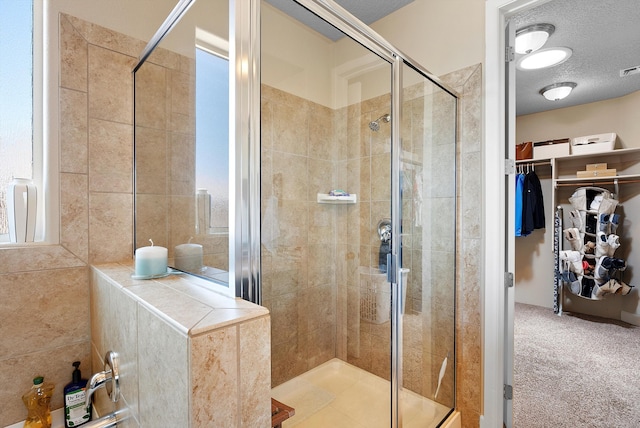 2659 Vista Manzano Loop NE, Rio Rancho, NM 87144 - bathroom with a shower stall, a spacious closet, and a textured ceiling