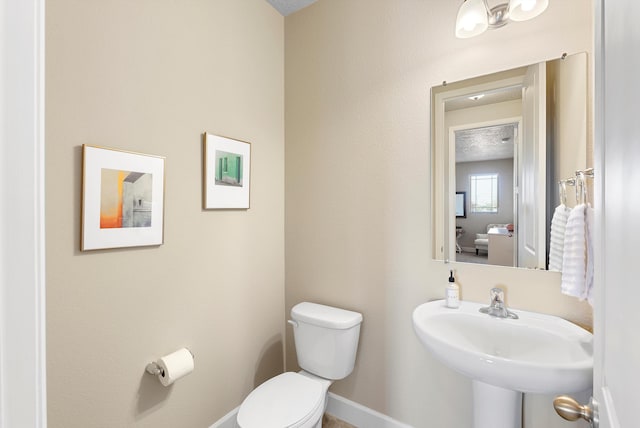 2659 Vista Manzano Loop NE, Rio Rancho, NM 87144 - half bath featuring toilet, baseboards, and a sink