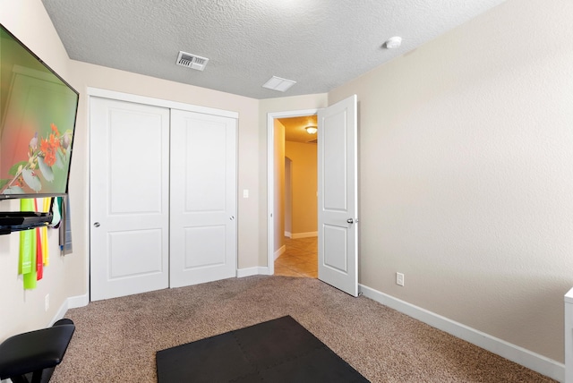 2659 Vista Manzano Loop NE, Rio Rancho, NM 87144 - unfurnished bedroom with carpet flooring, a closet, baseboards, and a textured ceiling