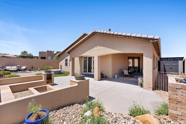 2659 Vista Manzano Loop NE, Rio Rancho, NM 87144 - back of property with stucco siding, a patio, and an outdoor hangout area