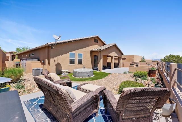 2659 Vista Manzano Loop NE, Rio Rancho, NM 87144 - rear view of house with a patio, stucco siding, central AC unit, a hot tub, and an outdoor living space