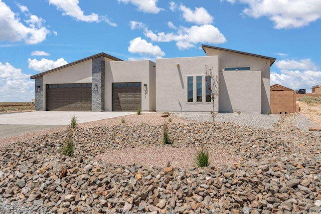 1413 6th St SE, Rio Rancho, NM 87124 - view of front of property with a garage, stucco siding, and concrete driveway