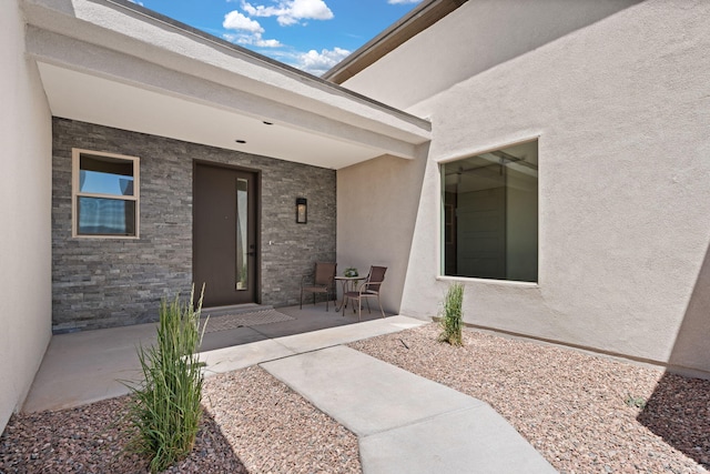 1413 6th St SE, Rio Rancho, NM 87124 - doorway to property with stucco siding and stone siding