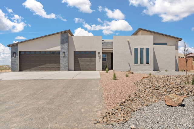 1413 6th St SE, Rio Rancho, NM 87124 - contemporary home with driveway, an attached garage, and stucco siding