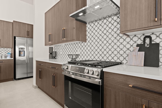 1413 6th St SE, Rio Rancho, NM 87124 - kitchen with appliances with stainless steel finishes, wall chimney range hood, backsplash, and light countertops
