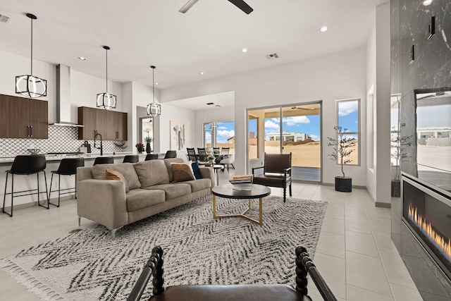 1413 6th St SE, Rio Rancho, NM 87124 - living area featuring recessed lighting, light tile patterned floors, ceiling fan, and a high ceiling