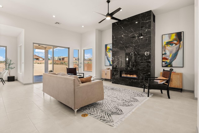 1413 6th St SE, Rio Rancho, NM 87124 - living area featuring a towering ceiling, ceiling fan, a premium fireplace, recessed lighting, and baseboards